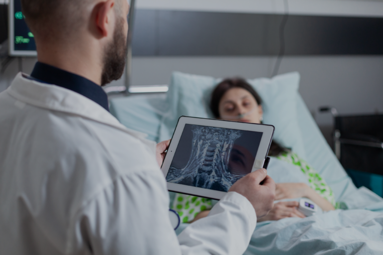 medic-holding-digital-tablet-with-throat-mri-looking-sleeping-patient-hospital-bed-after-throat-surgery-woman-resting-connected-screen-measuring-vitals-after-surgical-intervention 1